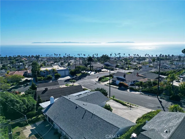 a view of a hallway with wooden floor and a bathroom