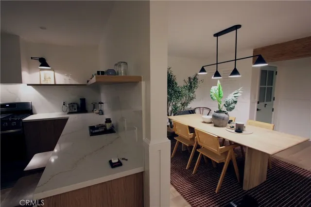 a living room with furniture a flat screen tv and a large window