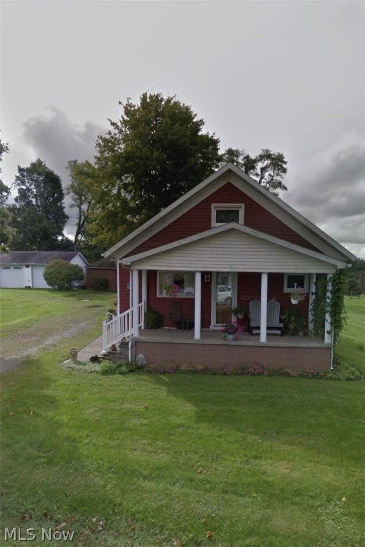 20002 Cadiz Road Quaker City, OH 43773 - Photo 1 of 19 View of front of house with covered porch and a front yard