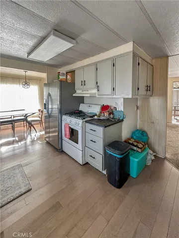 a kitchen with stainless steel appliances granite countertop a stove and cabinets