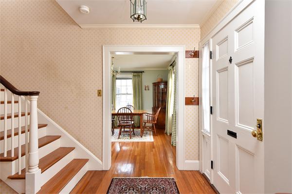 25 Chesterfield Road Milton, MA 02186 - Photo 6 of 27 a view of a hallway with wooden floor and dining room