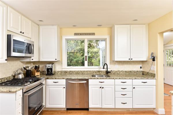 25 Chesterfield Road Milton, MA 02186 - Photo 9 of 27 a kitchen with granite countertop a sink cabinets stainless steel appliances and a window