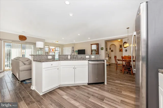 a kitchen with a refrigerator and table chair