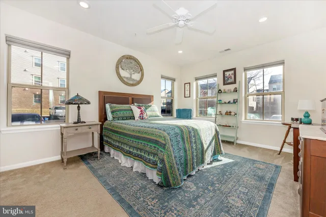 a bedroom with a bed a window and a chandelier