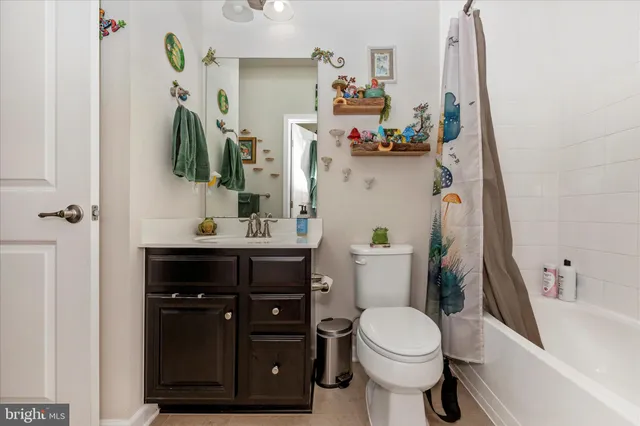 a bathroom with a sink vanity mirror and toilet