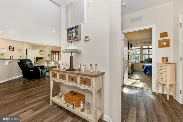 a living room with furniture a fireplace and wooden floor