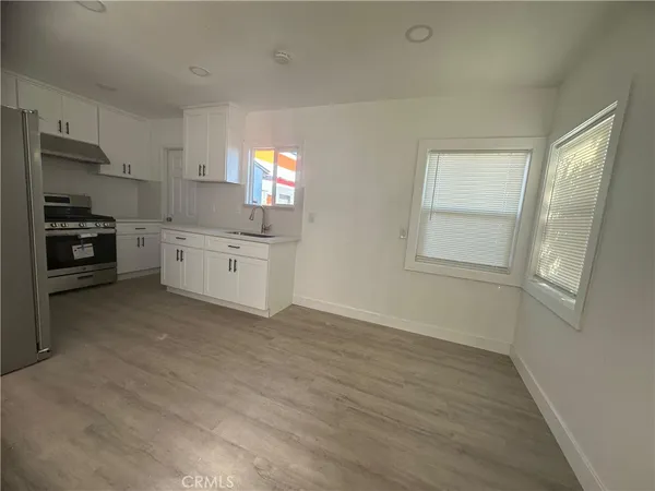 a kitchen with granite countertop a stove and a refrigerator