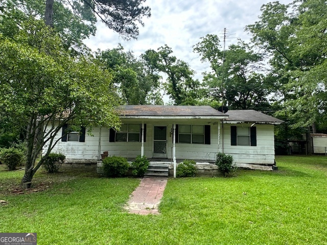 a front view of house with yard and green space