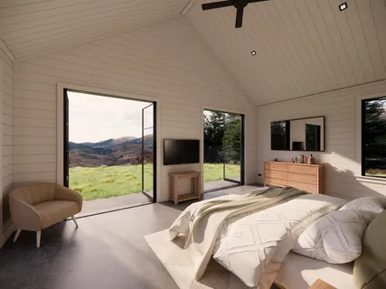 a bedroom with a bed and a flat tv screen on the dresser