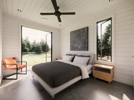 a bedroom with a large bed and a large window