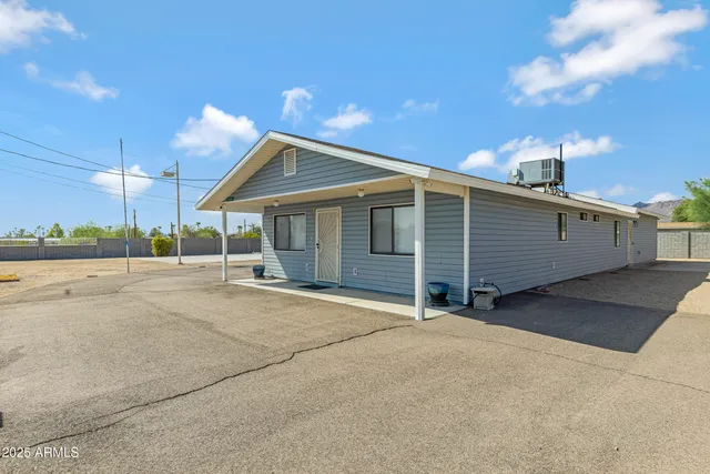 a view of a house with a backyard and garage
