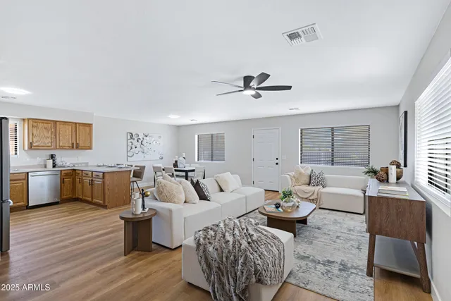a living room with furniture wooden floor and a view of kitchen