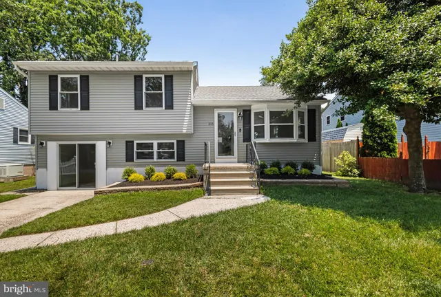 a front view of a house with garden and porch