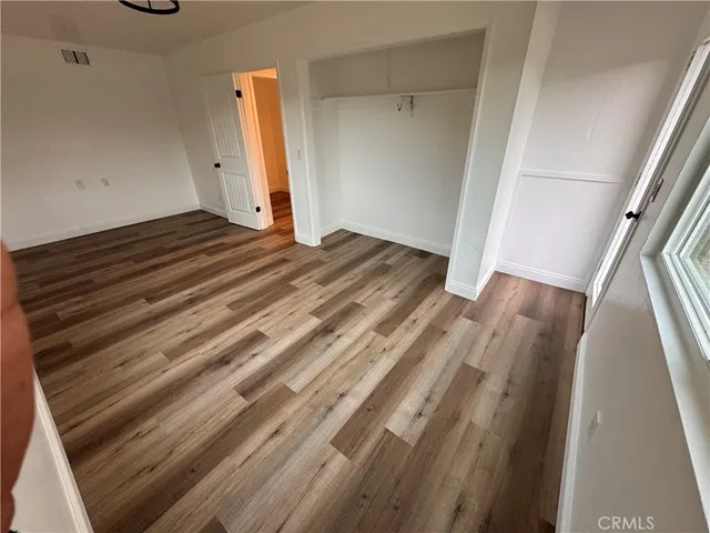 a view of a room with wooden floor and stairs