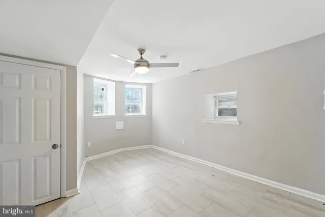 a view of a big room with closet and windows