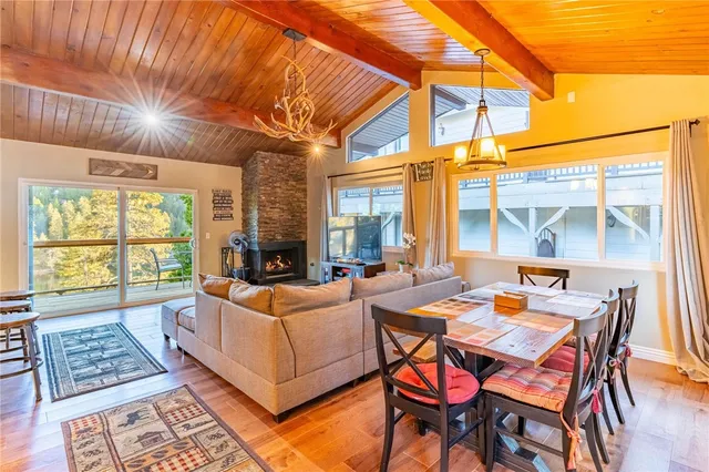 a living room with furniture a table and chairs next to a window