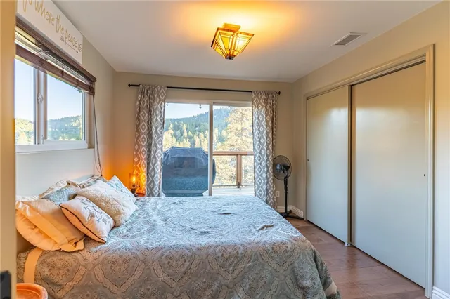 a bedroom with a bed and a dresser next to a window