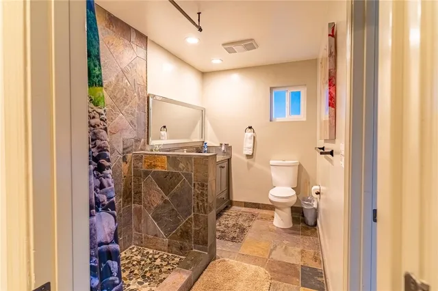 a bathroom with a toilet and shower