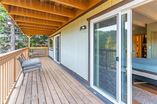 a view of balcony with wooden floor and iron stairs