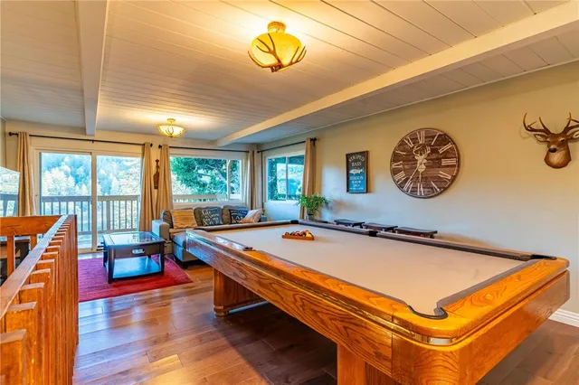 a room with pool table and windows