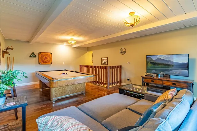 a living room with patio furniture and a flat screen tv