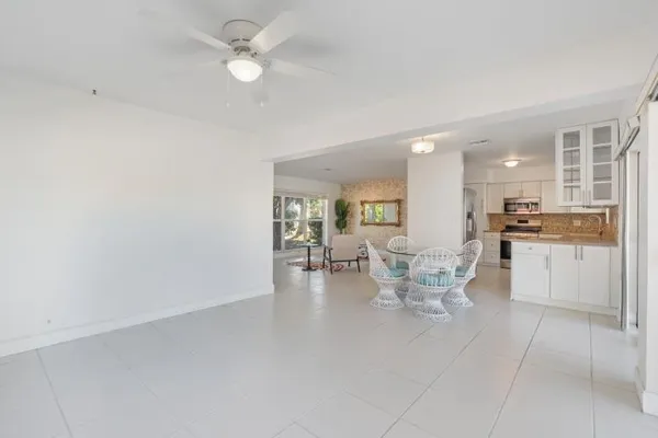 a view of a kitchen with dining table and chairs