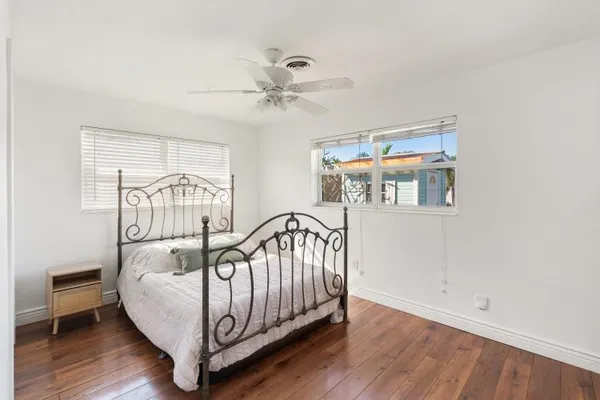 a bedroom with furniture and wooden floor