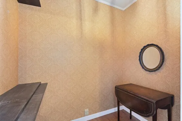 a room with a wooden wall and a window