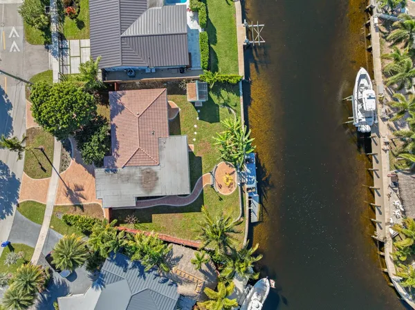 an aerial view of residential houses with outdoor space lake view and boat