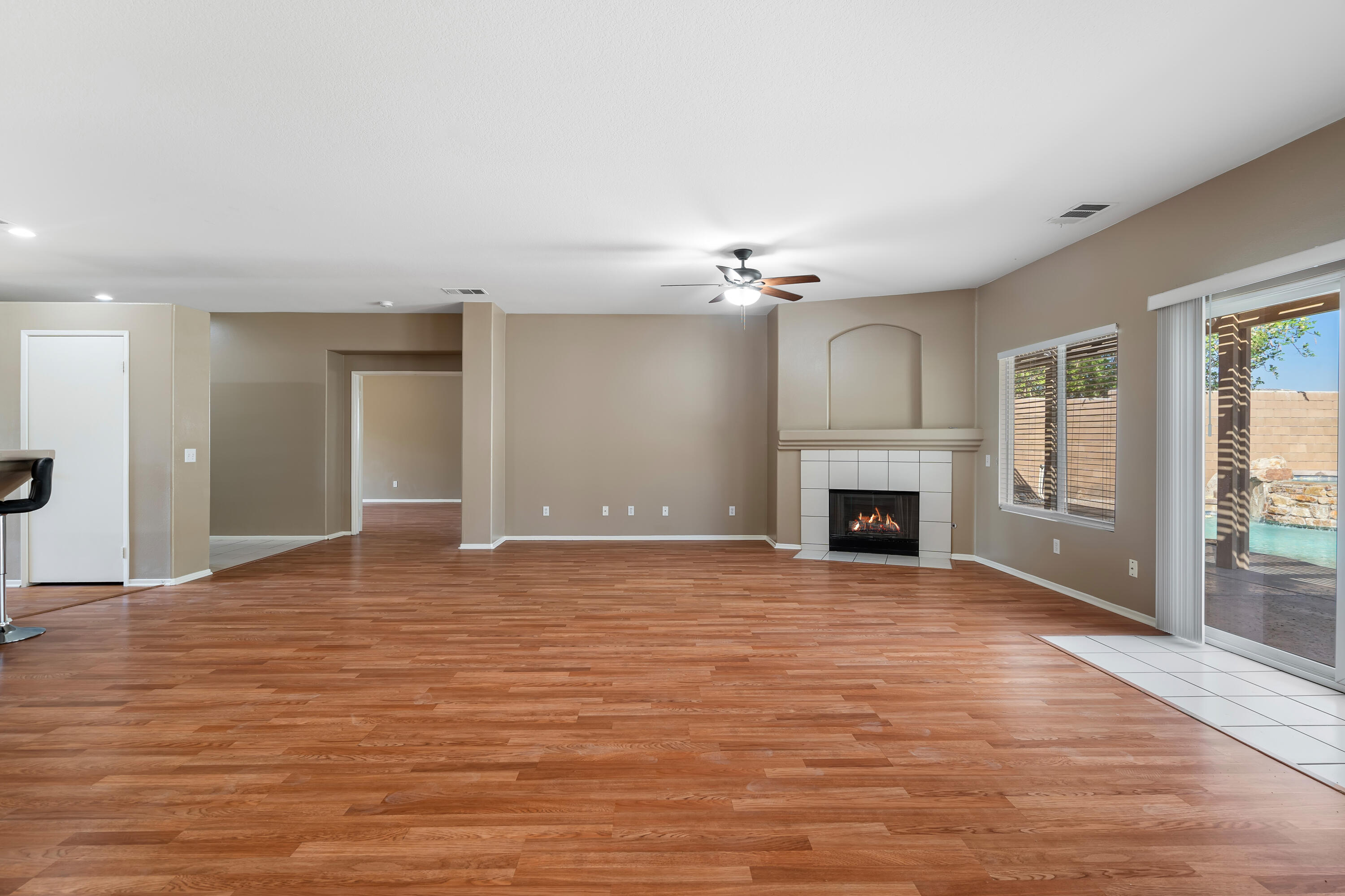 83160 Shadow Hills Way Indio, CA 92203 - Photo 12 of 50 a view of an empty room with wooden floor fireplace and a window
