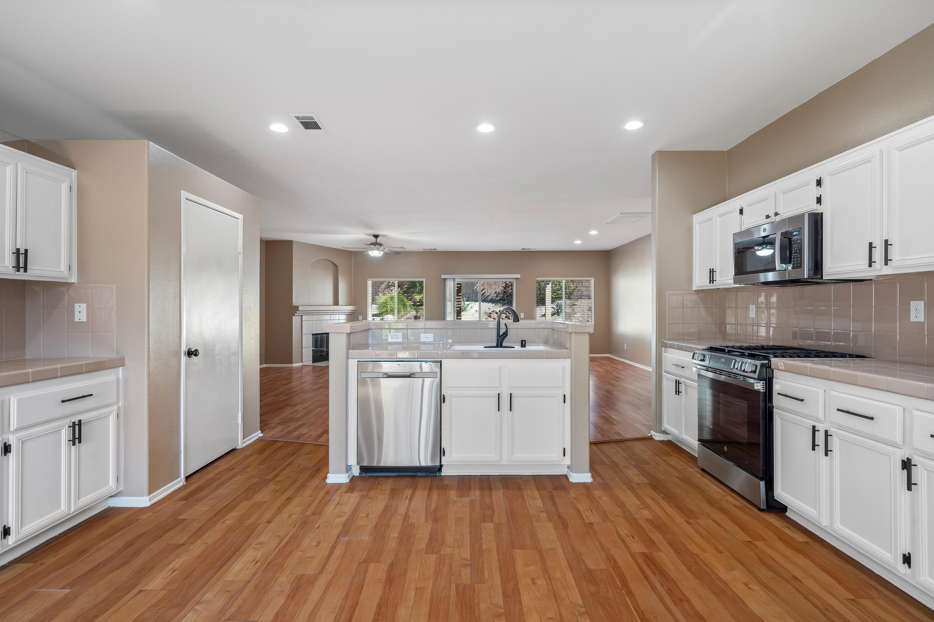 83160 Shadow Hills Way Indio, CA 92203 - Photo 15 of 50 a kitchen with wooden floors and white appliances