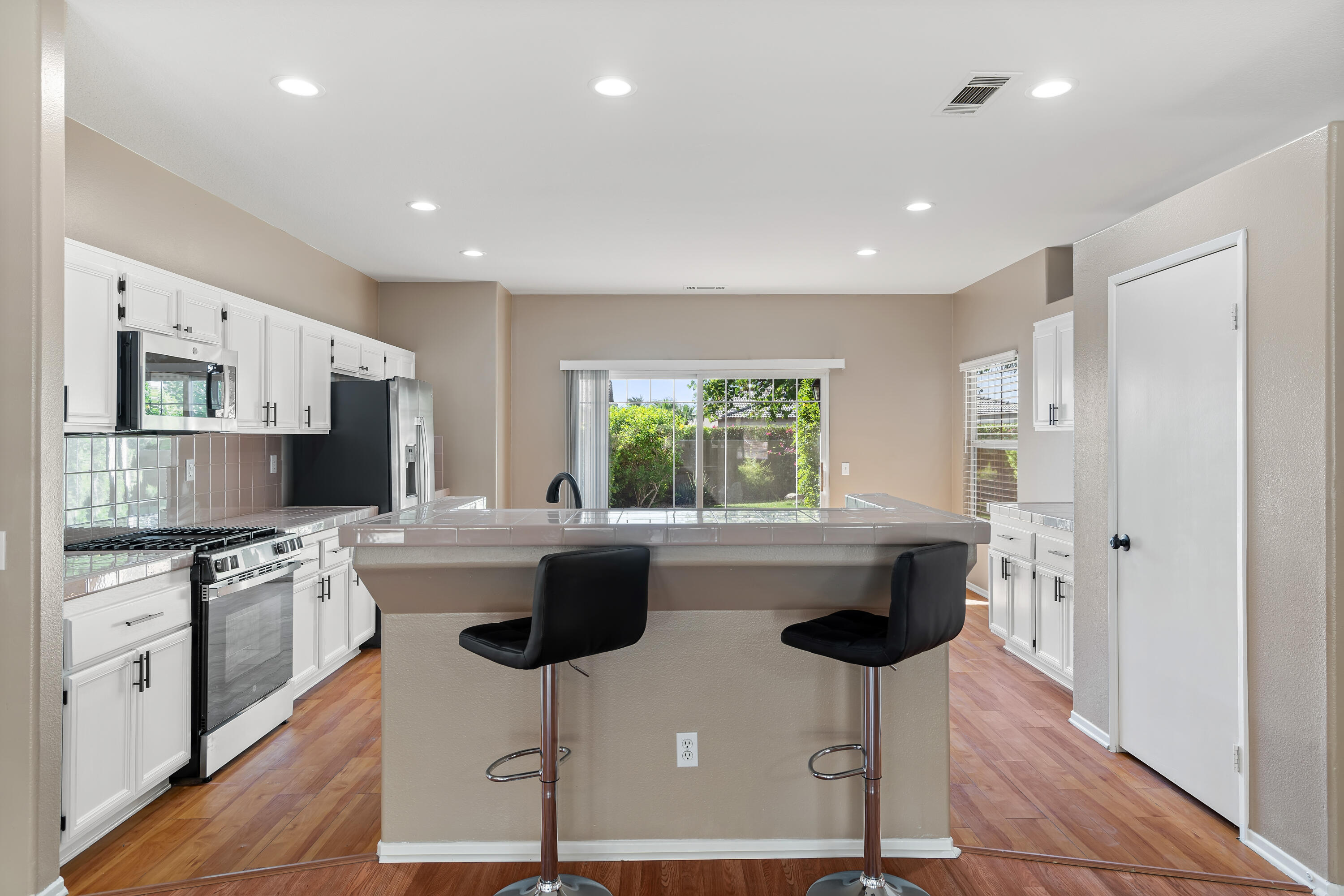 83160 Shadow Hills Way Indio, CA 92203 - Photo 16 of 50 a kitchen with kitchen island a sink stainless steel appliances and window