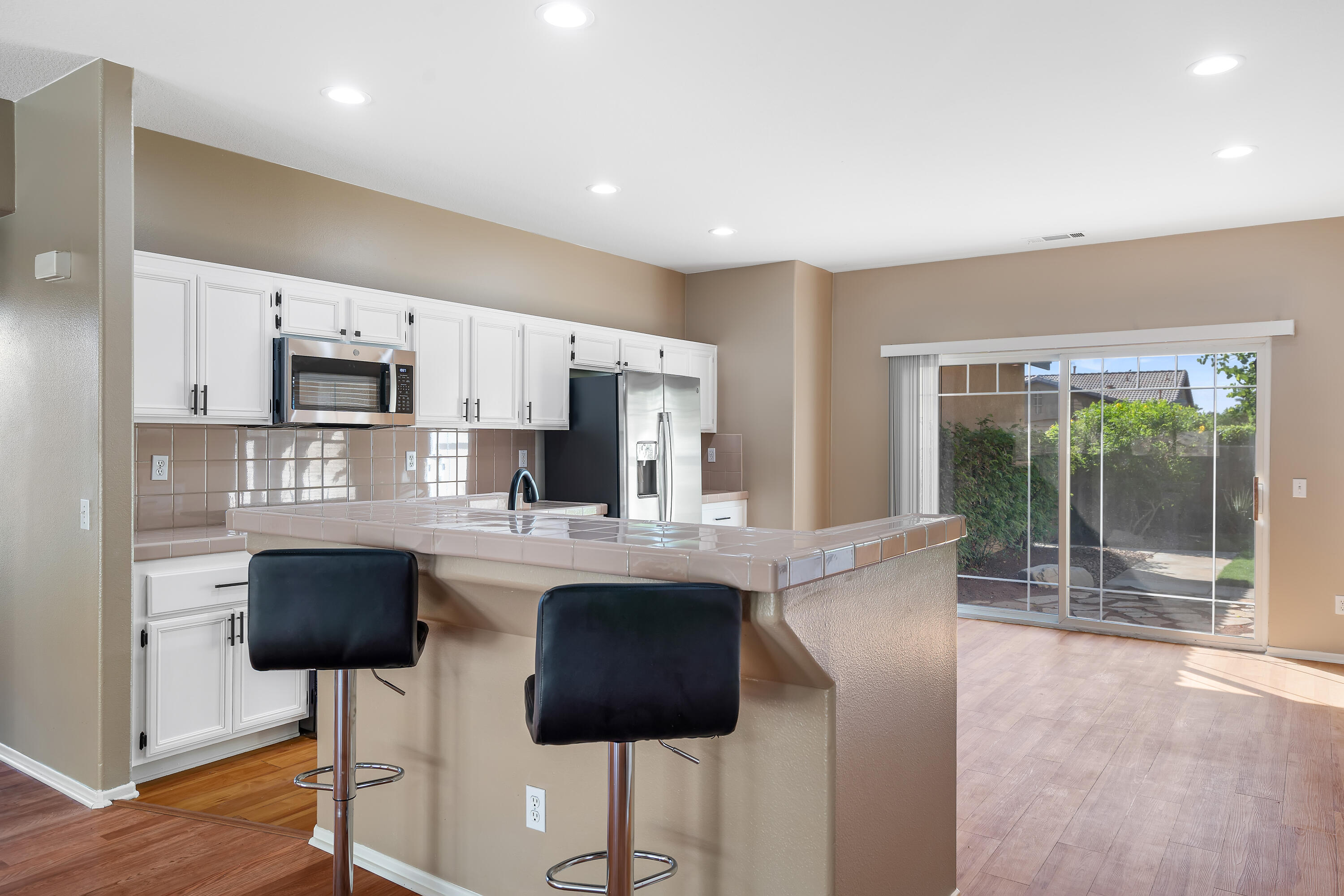 83160 Shadow Hills Way Indio, CA 92203 - Photo 17 of 50 a kitchen with stainless steel appliances a stove a sink a microwave a refrigerator and chairs