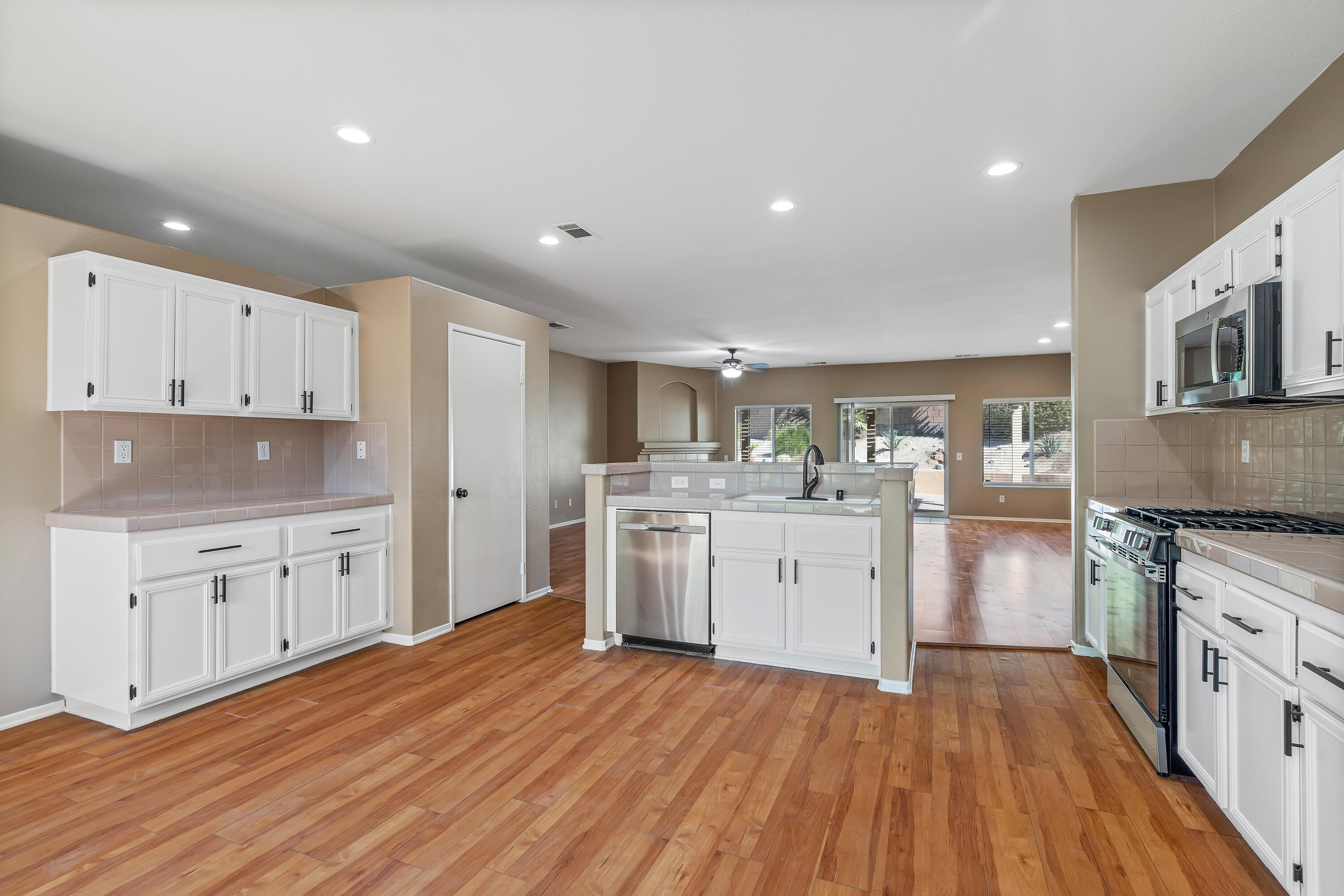 83160 Shadow Hills Way Indio, CA 92203 - Photo 21 of 50 a kitchen with granite countertop a stove top oven sink and cabinets
