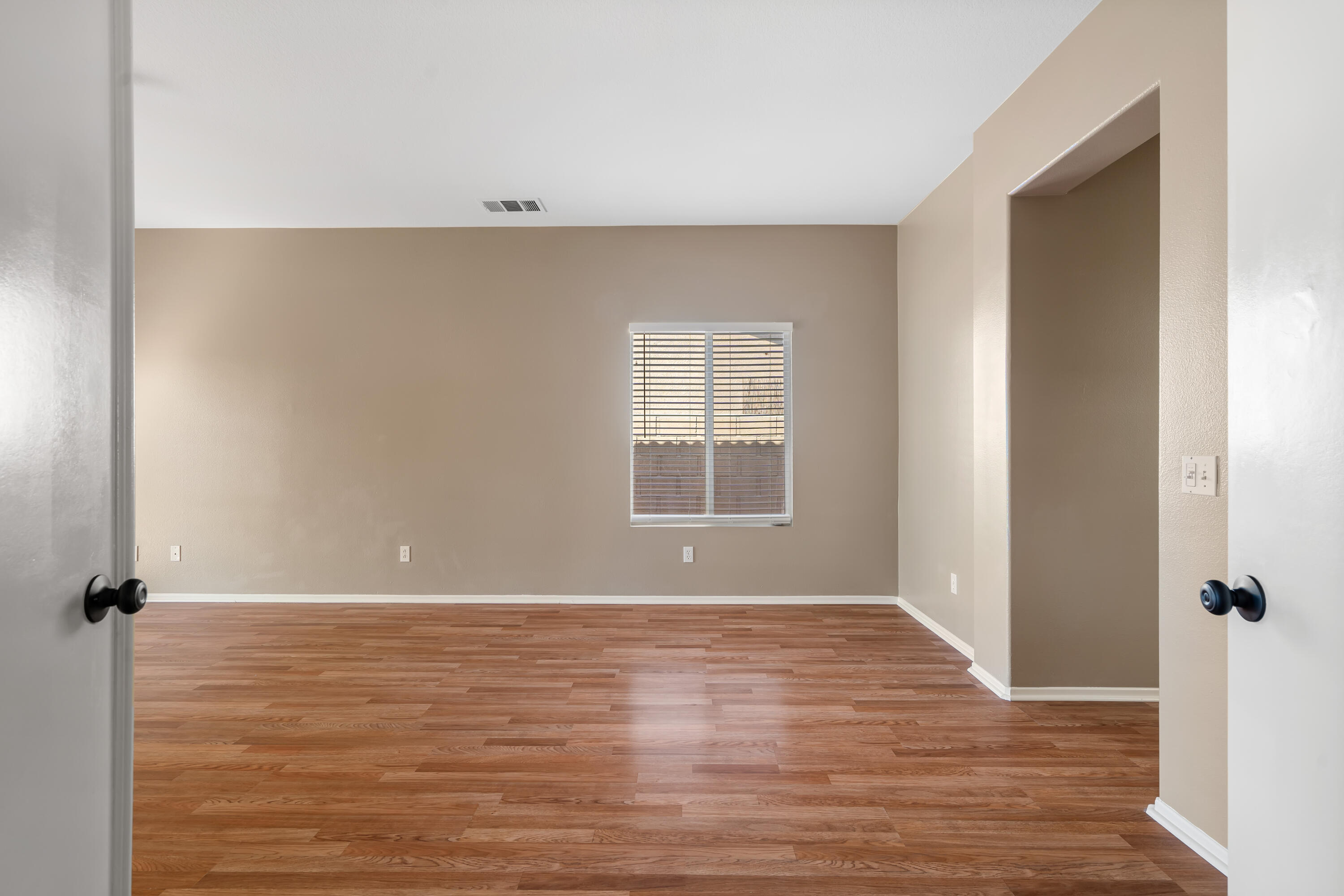 83160 Shadow Hills Way Indio, CA 92203 - Photo 23 of 50 a view of an empty room with wooden floor and a window