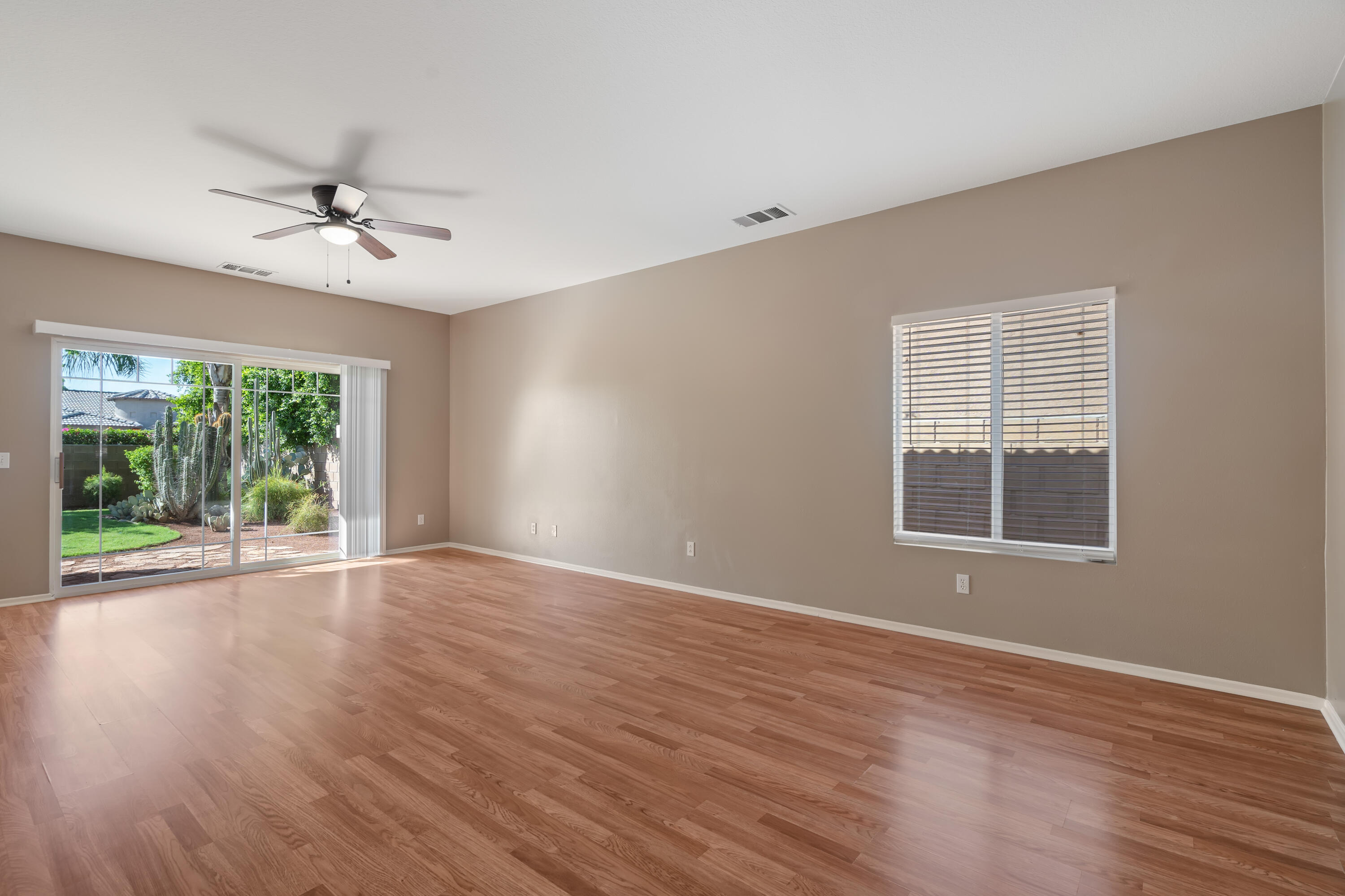83160 Shadow Hills Way Indio, CA 92203 - Photo 24 of 50 a view of an empty room with wooden floor and a window