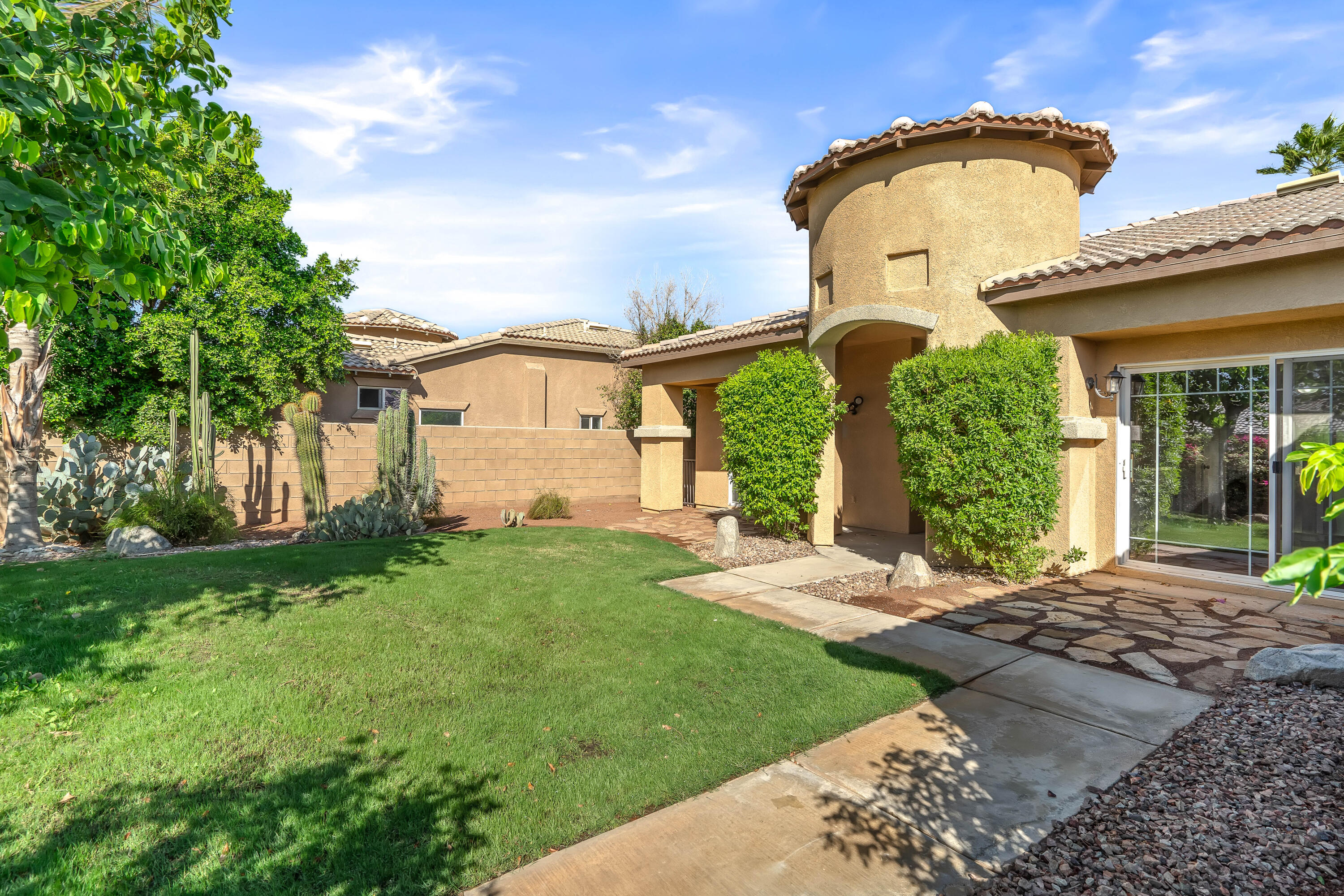 83160 Shadow Hills Way Indio, CA 92203 - Photo 3 of 50 a front view of a house with garden
