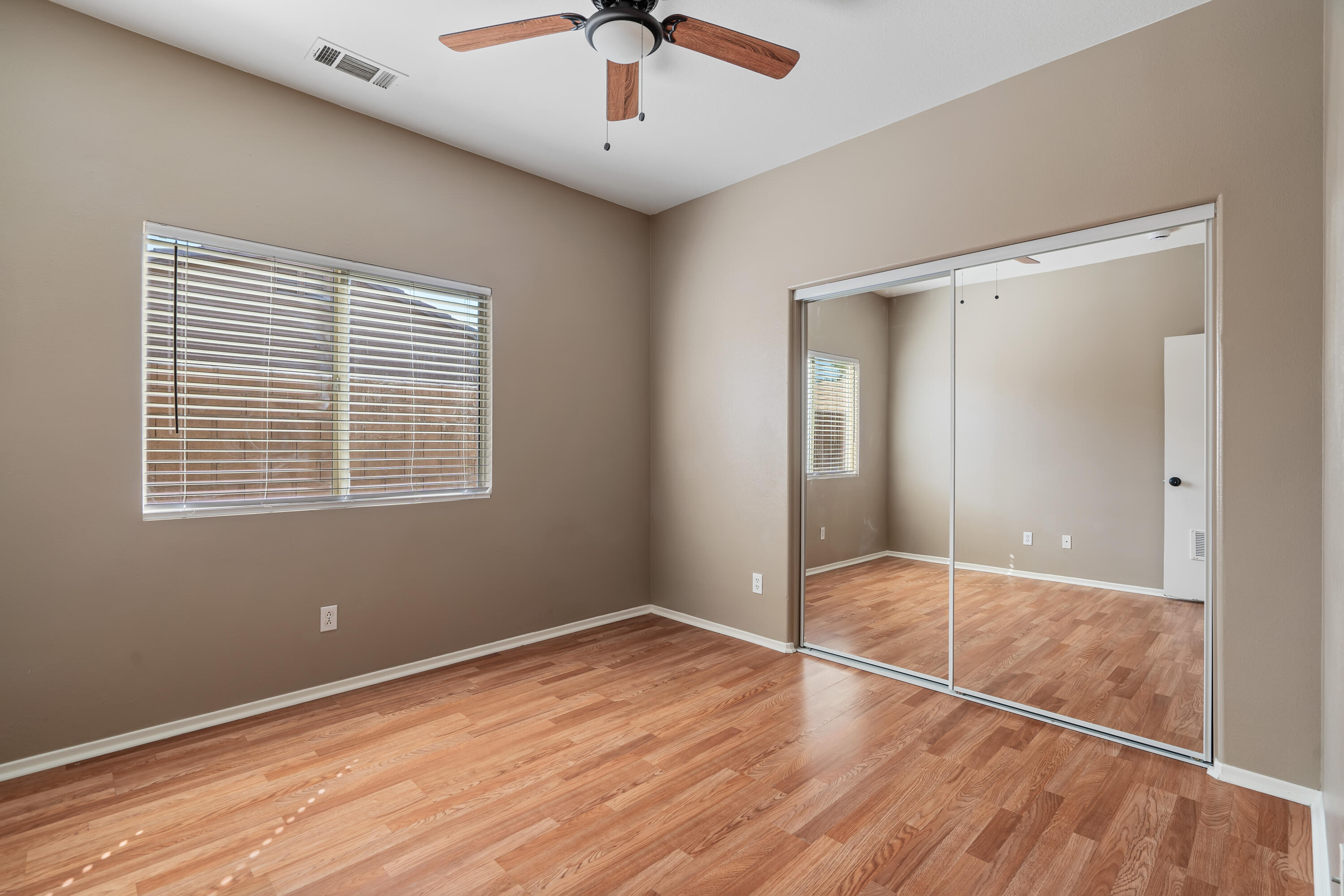 83160 Shadow Hills Way Indio, CA 92203 - Photo 38 of 50 a view of an empty room with wooden floor and a window