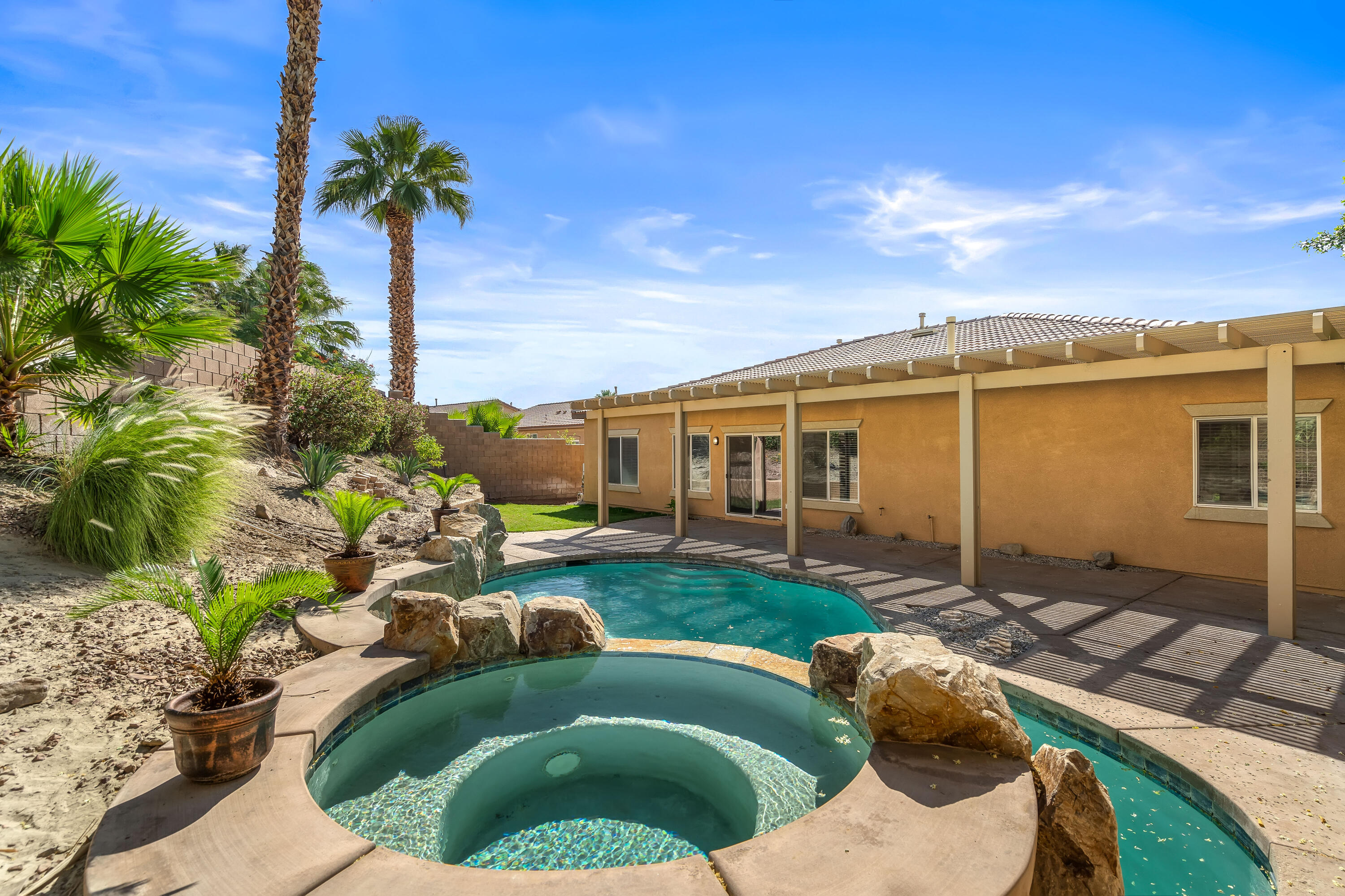 83160 Shadow Hills Way Indio, CA 92203 - Photo 46 of 50 a view of a house with backyard sitting area and swimming pool