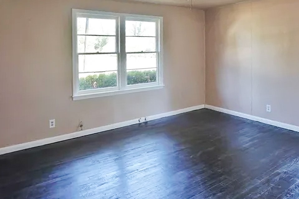 4425 Harding Drive Beaumont, TX 77703 - Photo 12 of 16 an empty room with wooden floor and windows