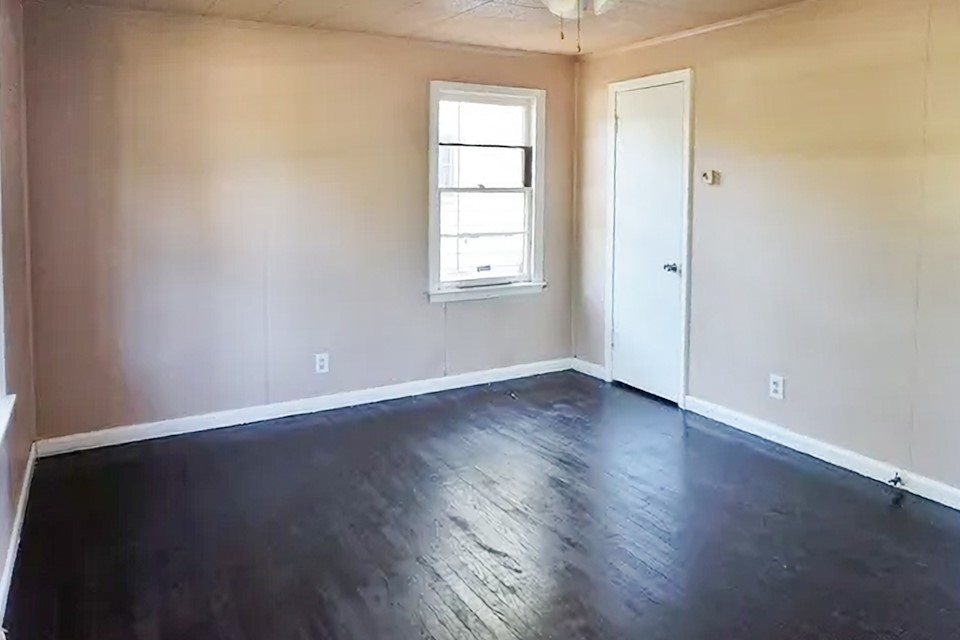 4425 Harding Drive Beaumont, TX 77703 - Photo 13 of 16 an empty room with wooden floor and windows