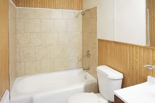 a bathroom with a toilet and a bathtub