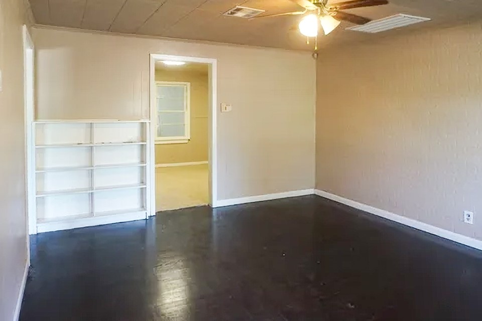 4425 Harding Drive Beaumont, TX 77703 - Photo 3 of 16 an empty room with wooden floor and fan