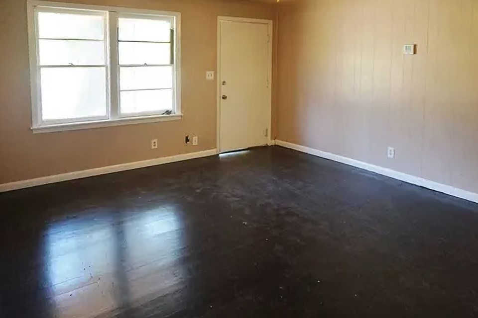 4425 Harding Drive Beaumont, TX 77703 - Photo 5 of 16 an empty room with wooden floor and windows