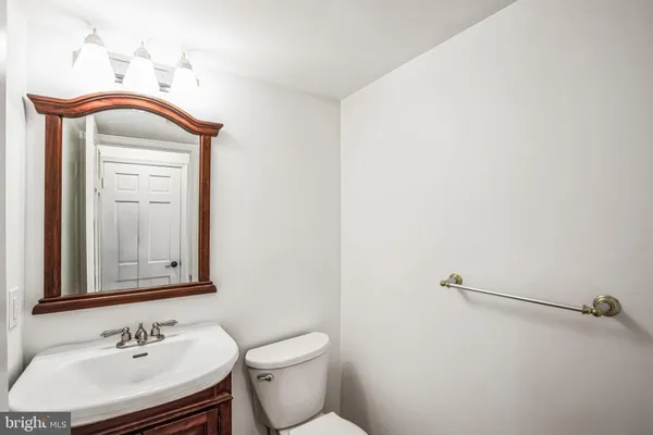 a bathroom with a sink a toilet and mirror