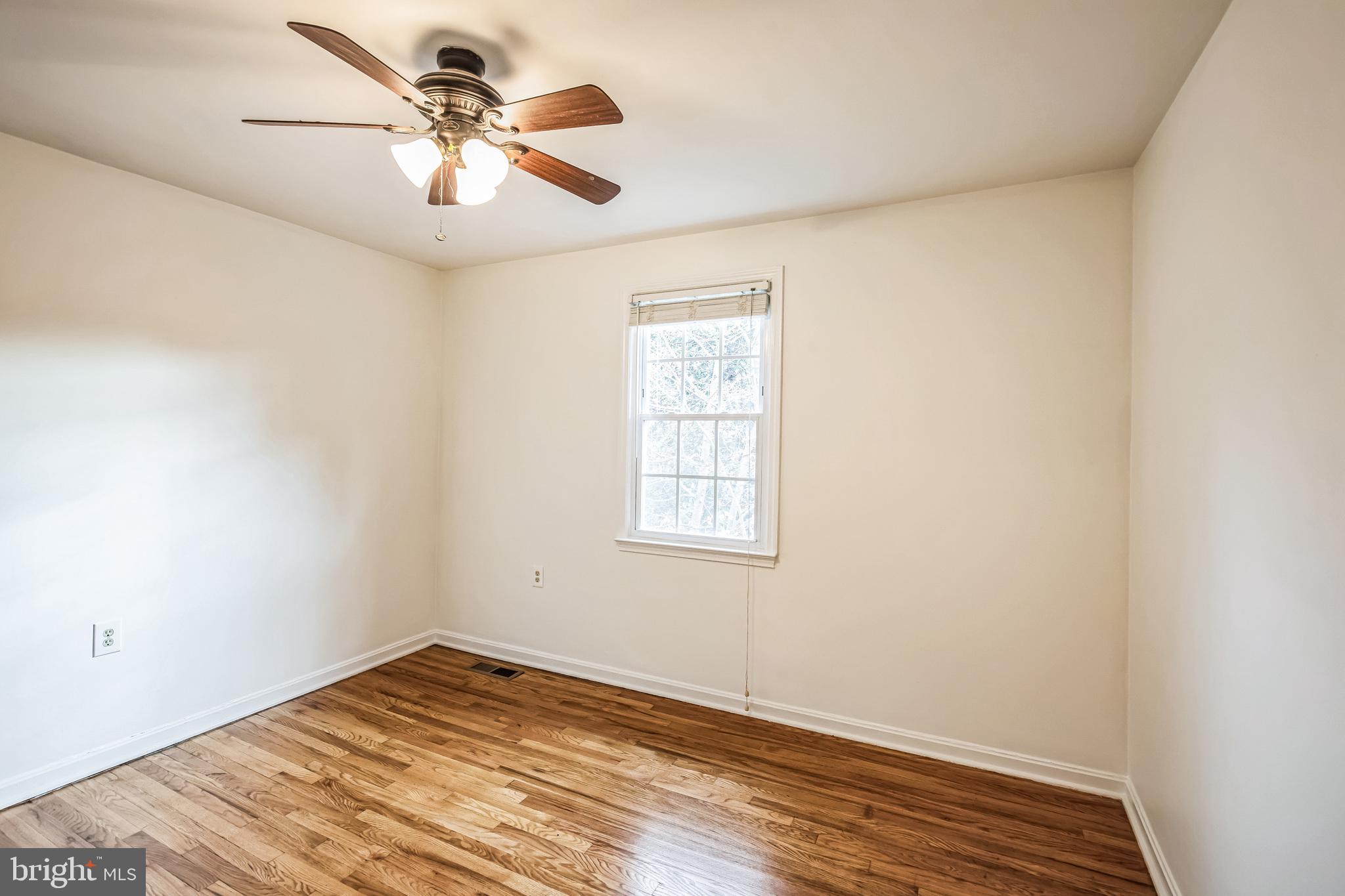 1772 Dryden Way Crofton, MD 21114 - Photo 22 of 34 an empty room with wooden floor and windows