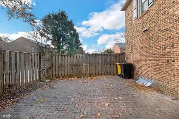 a view of a backyard with a fence and plants
