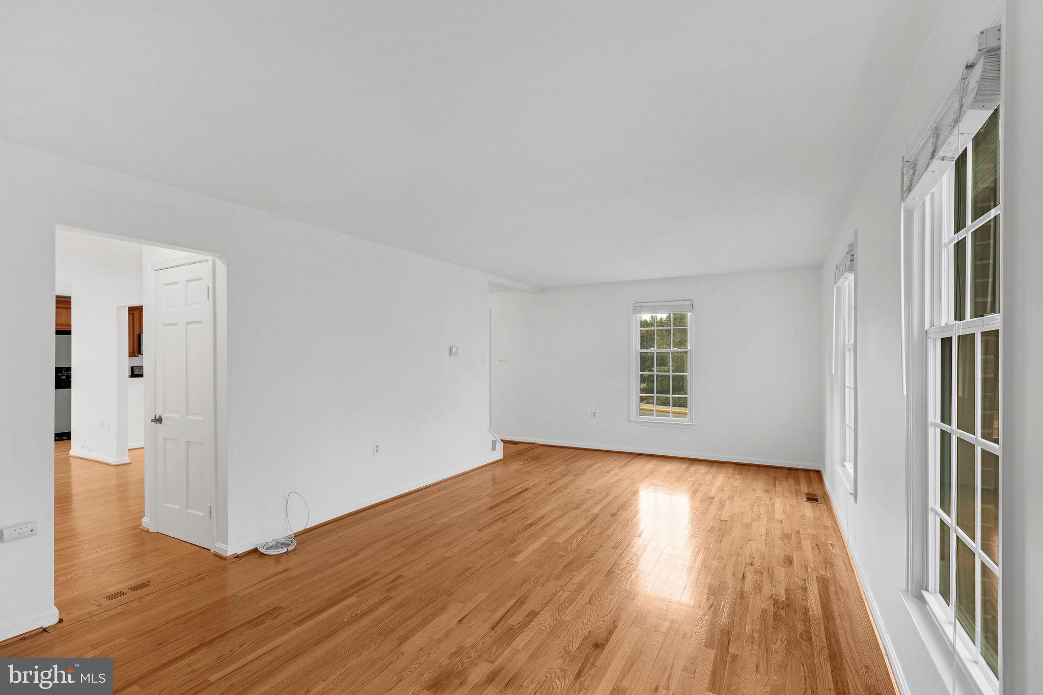 1772 Dryden Way Crofton, MD 21114 - Photo 7 of 34 an empty room with wooden floor and windows