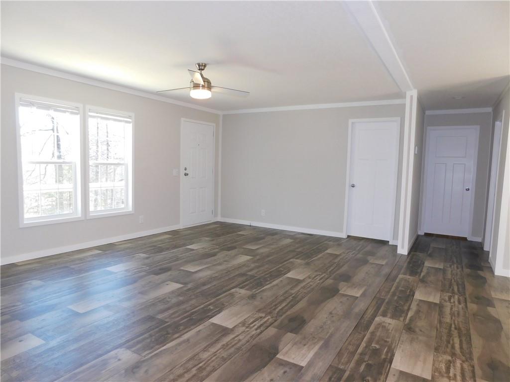 350 Galahad Road Dahlonega, GA 30533 - Photo 11 of 39 a view of an empty room with wooden floor and a window
