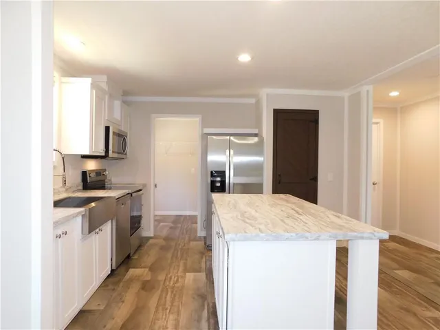 a kitchen with a sink and refrigerator